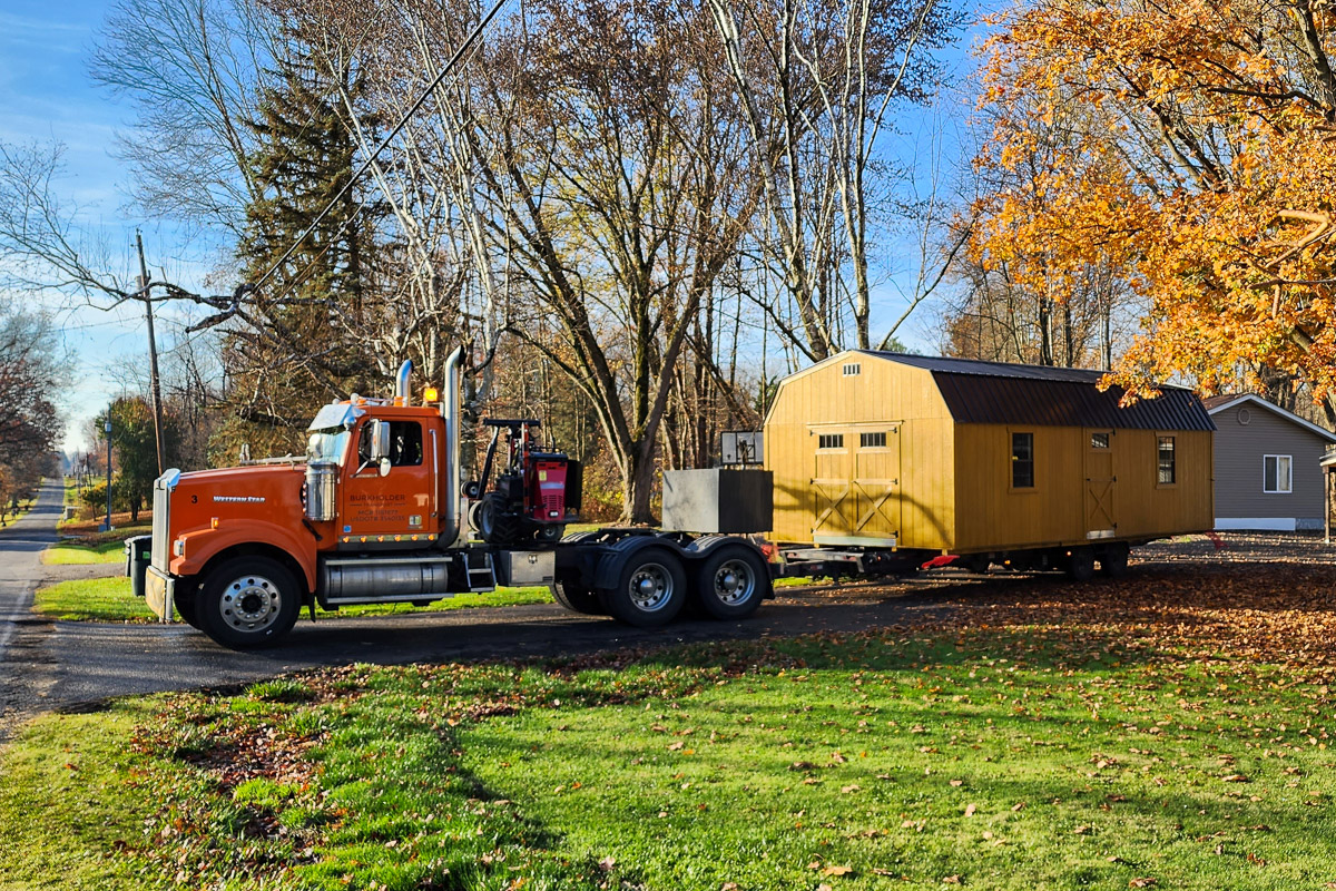 TruPoint delivery truck placing a storage building