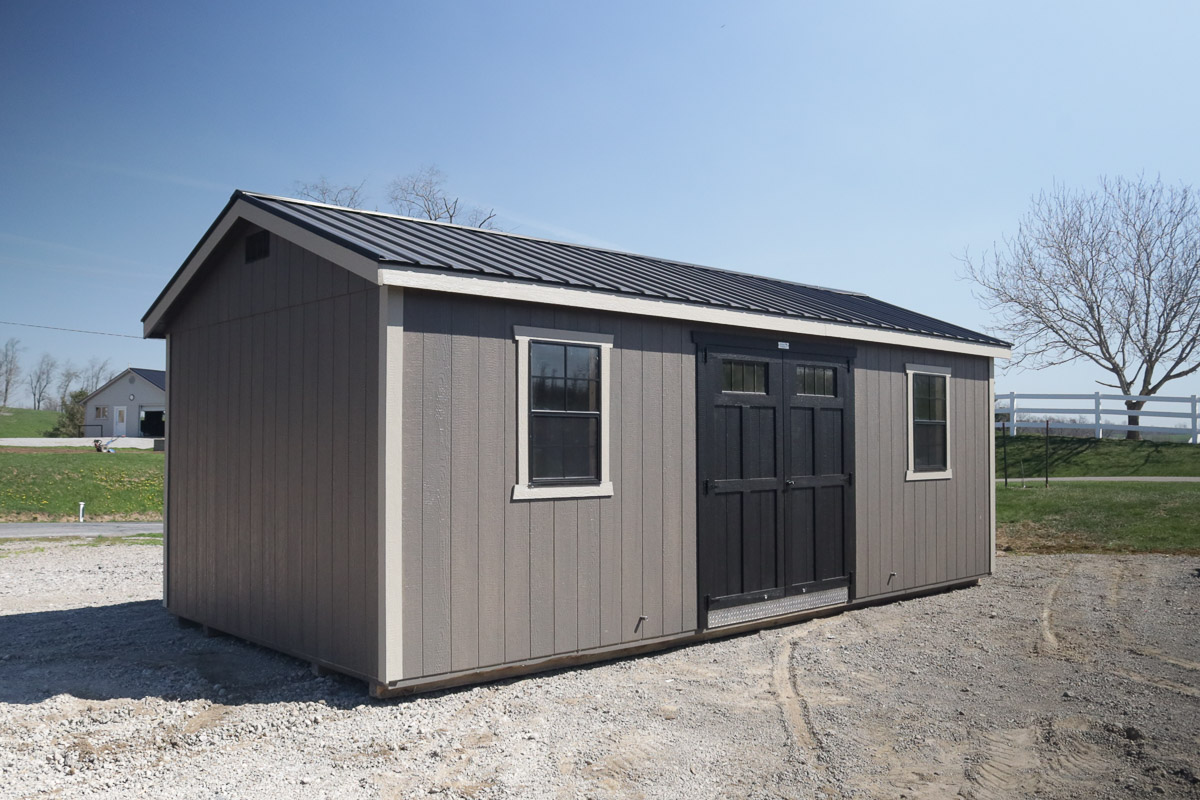 Gray storage shed with dark double barn doors